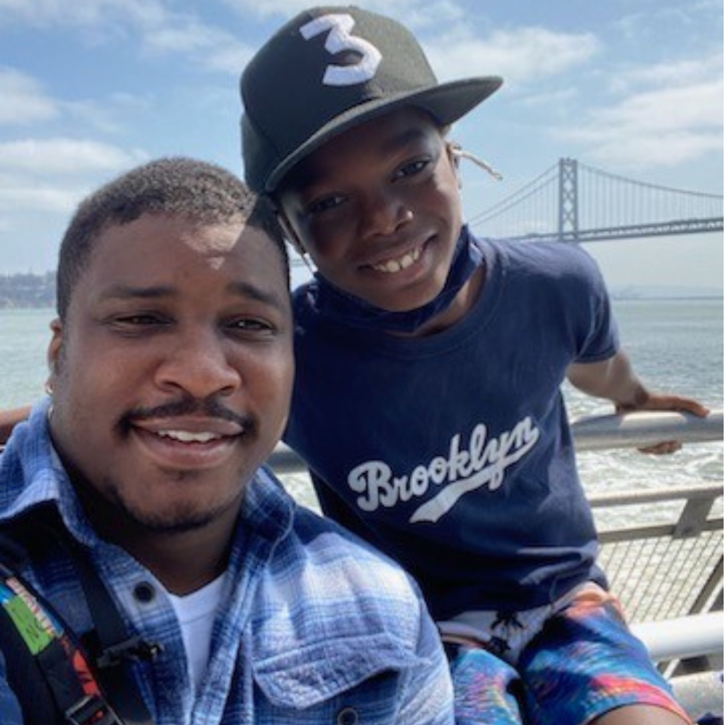 Alvin and Eugene on a boat in front of the bay bridge